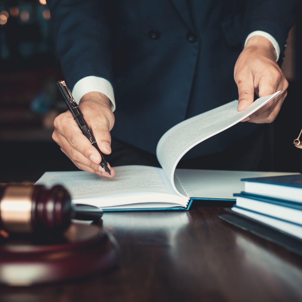 Legal documents being filed in a courtroom.