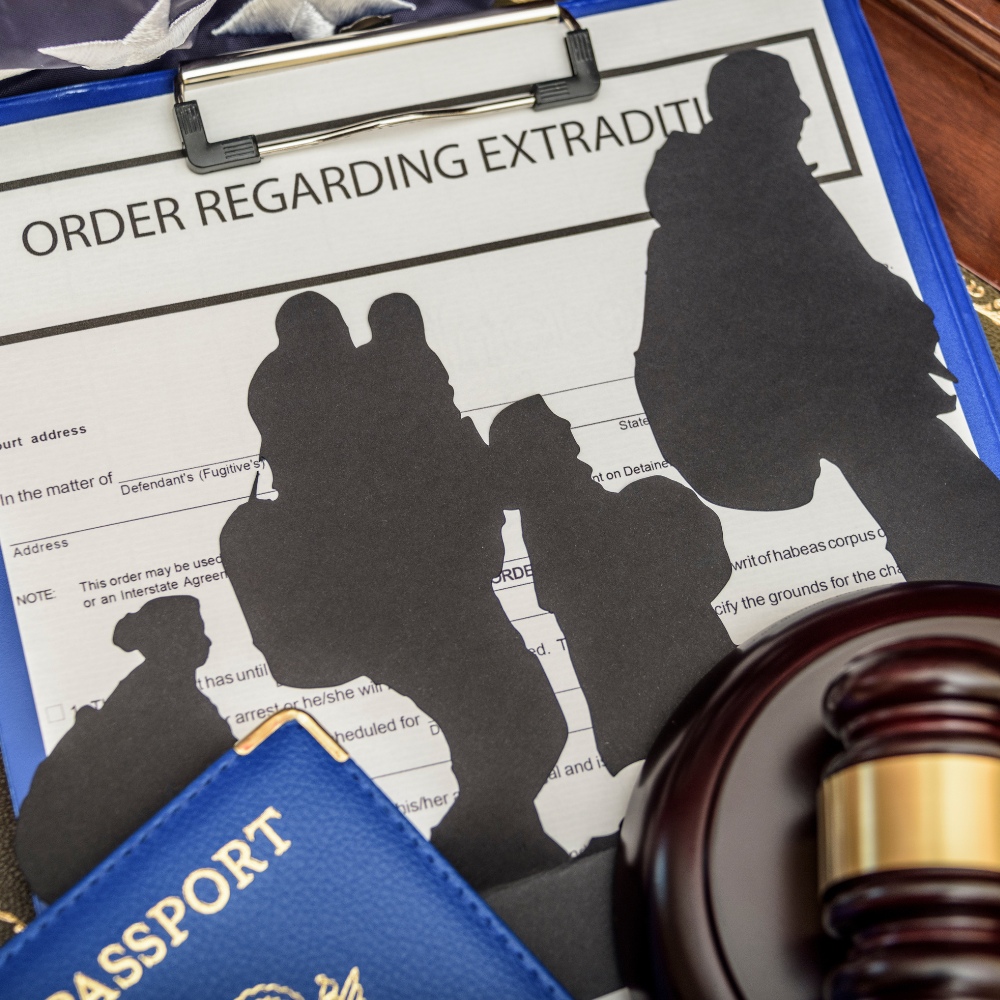 Legal documents pertaining to extradition with a gavel and passport, suggesting a judicial process involving international law.