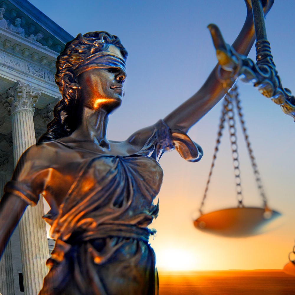 A balanced scale held by Lady Justice, representing fairness and impartiality in the legal system.