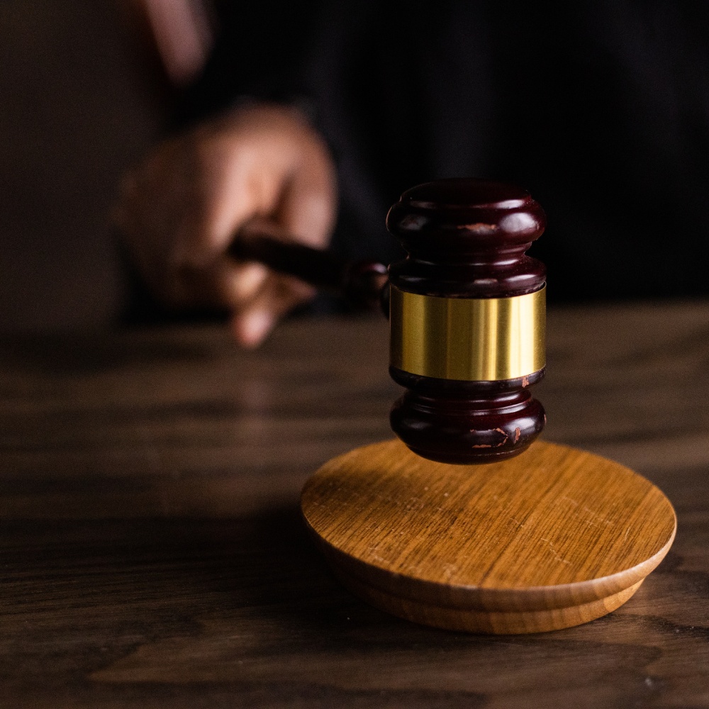 Gavel resting on a wooden table, symbolizing justice and authority